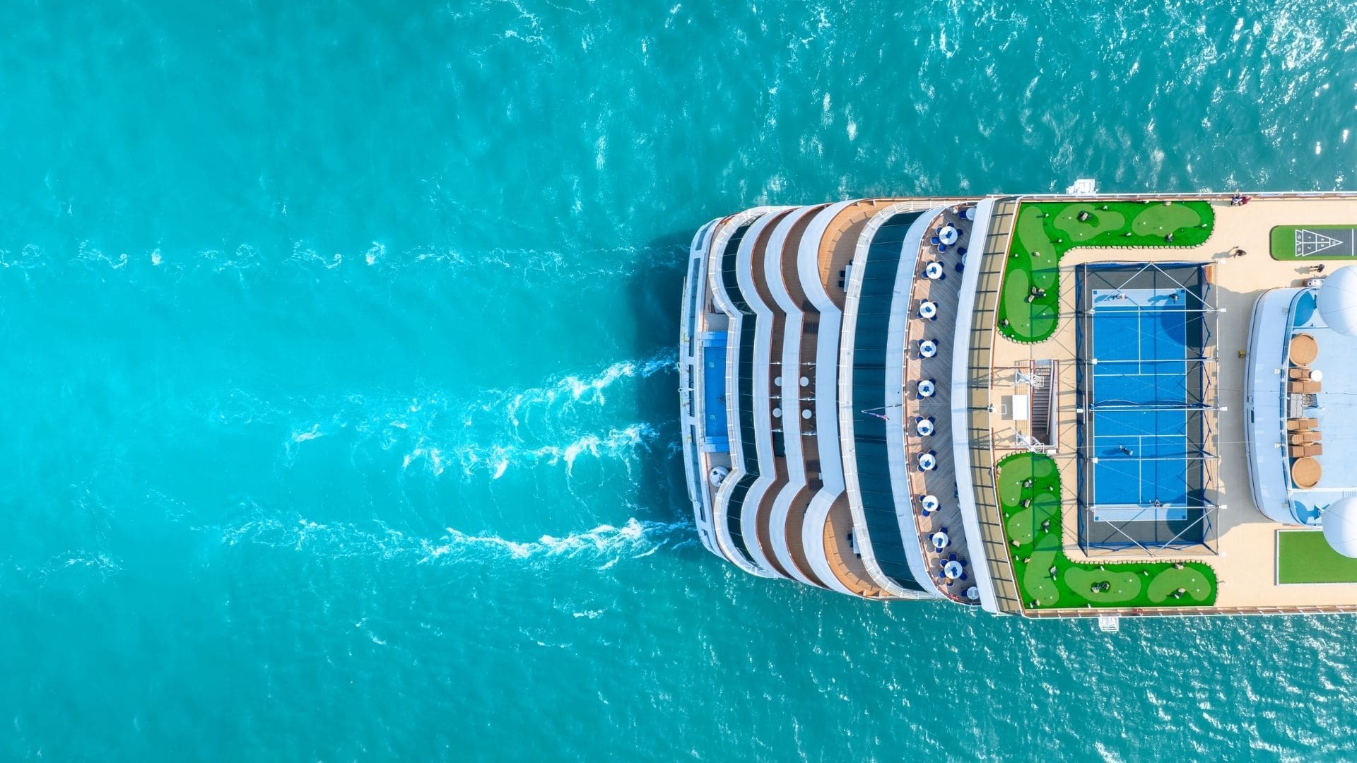 A ship sailing on beautiful turquoise water.